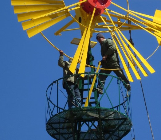 Men working on windwater wheel
